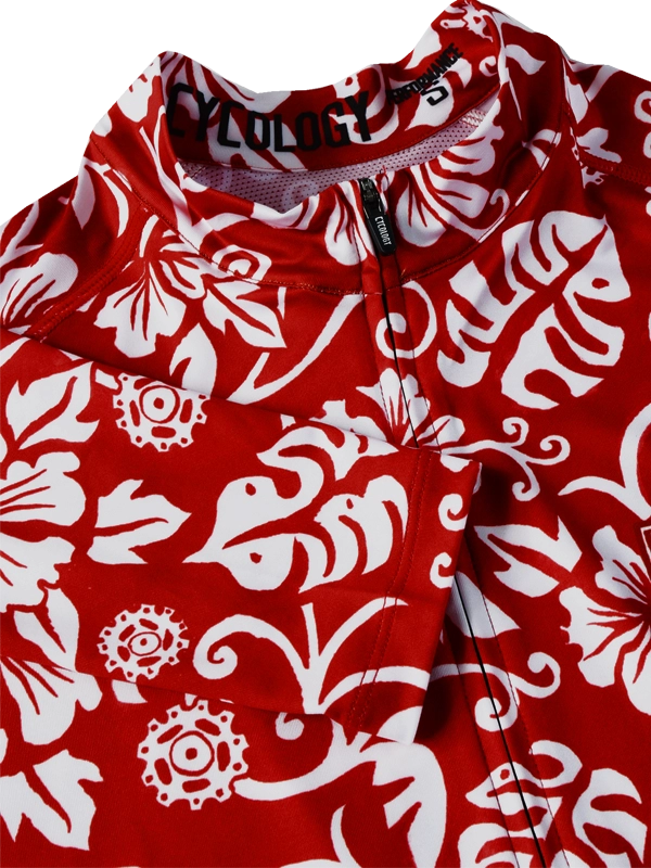 Close up of Red and white men's floral patterned long-sleeve cycling jersey with CYCOLOGY branding 