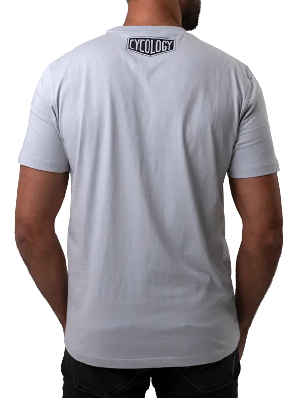 Person wearing a gray t-shirt with 'Cycology' branding on the back.