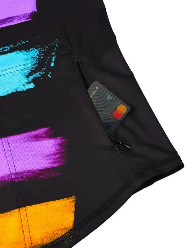 Black cycling shorts with colorful abstract design and secure zip pocket for essentials