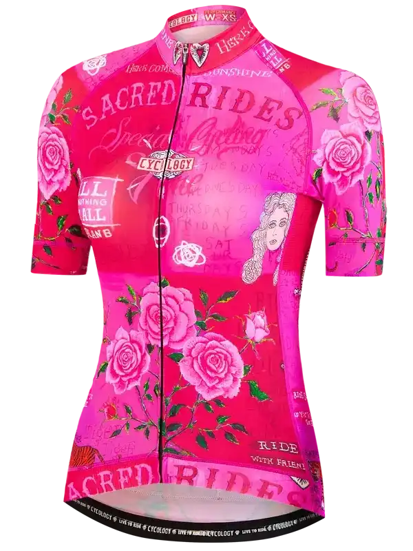 Women's pink cycling jersey with rose print and 'Sacred Rides' text, featuring short sleeves and full zipper for bike rides.