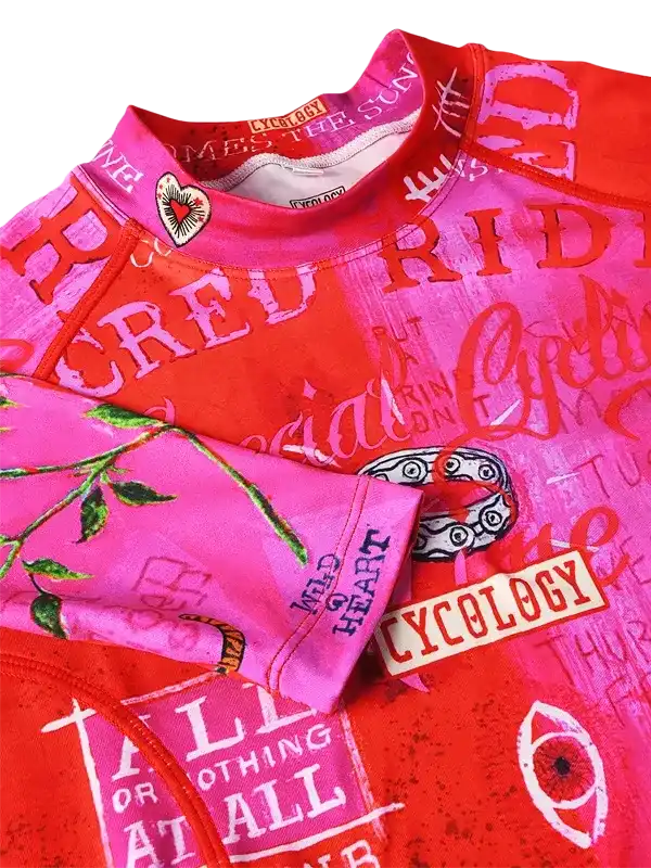 Vibrant pink and red cycling jersey with bold graphics and text, featuring unique designs for men and women.