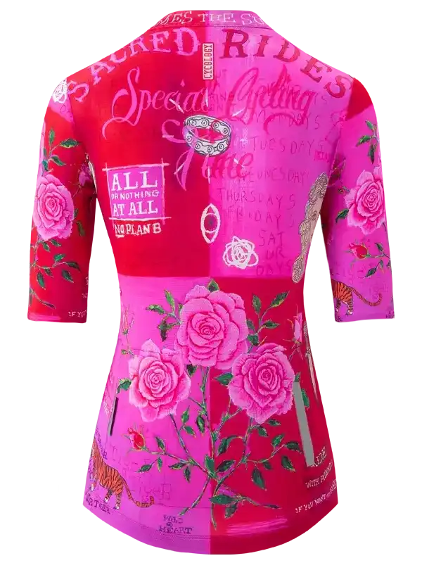 Women's pink cycling jersey with rose print, floral design, and motivational text for road rides