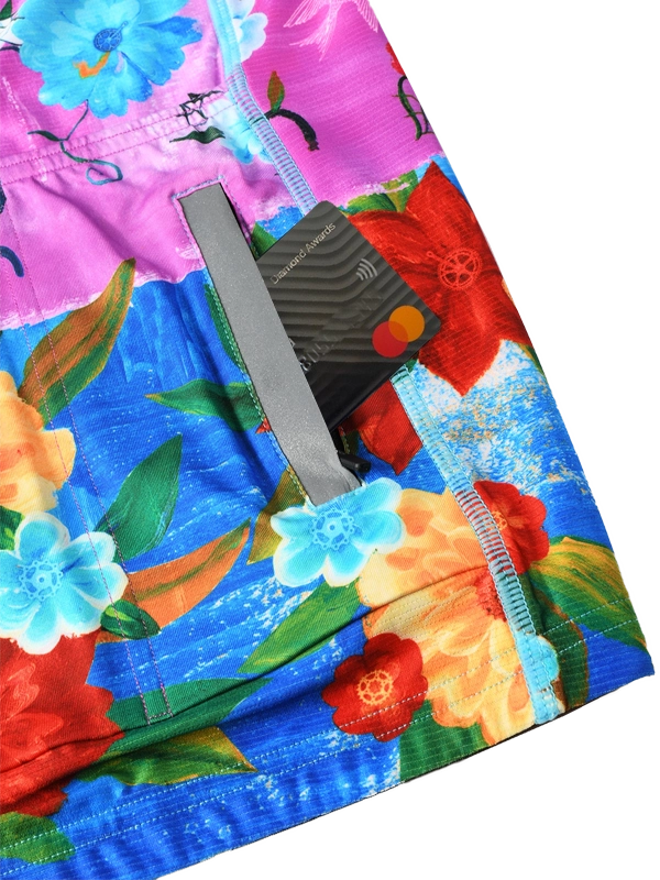 Colorful women's long sleeve  cycling jersey with floral design and 'Cycology' branding on a pink and blue background back pockets