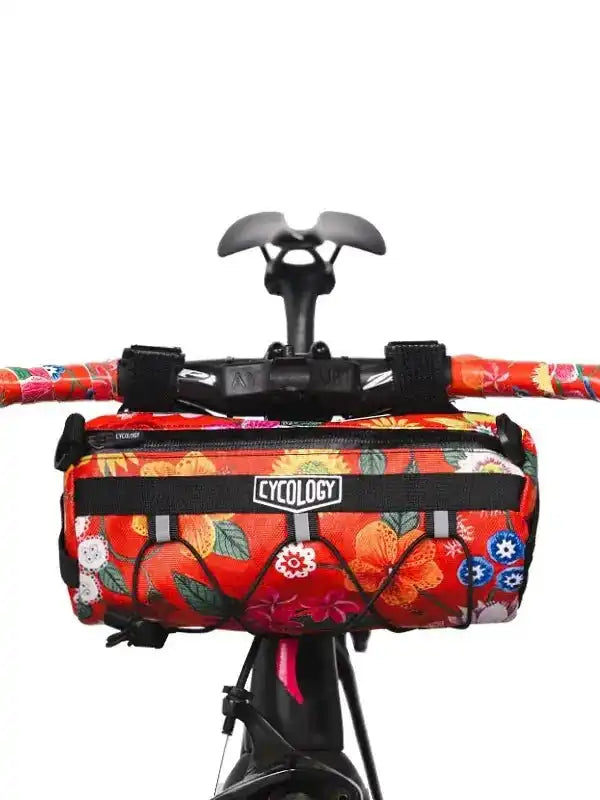 Vibrant floral cycling handlebar bag with Cycology logo, perfect for bike adventures and gear storage.