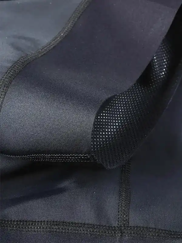 Black cycling jersey with breathable mesh panel and flatlock seams for comfort