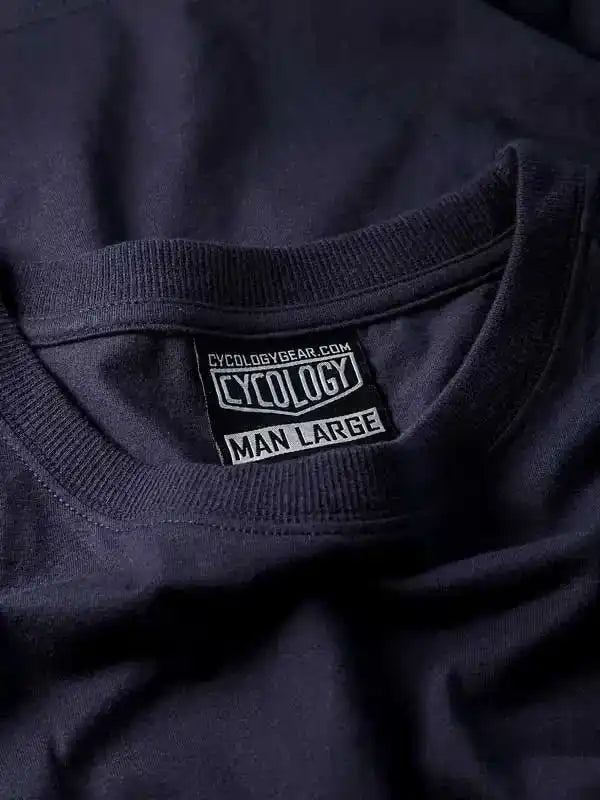 Cycology men's large cycling shirt tag with brand logo and size label on dark fabric