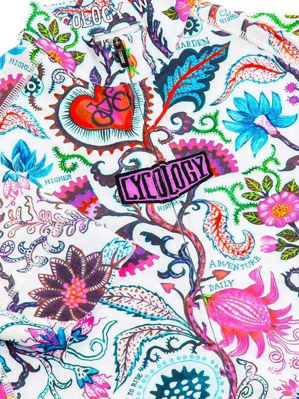 Vibrant floral and gear-patterned cycling jersey with 'Cycology' logo, ideal for women's and men's bike rides.