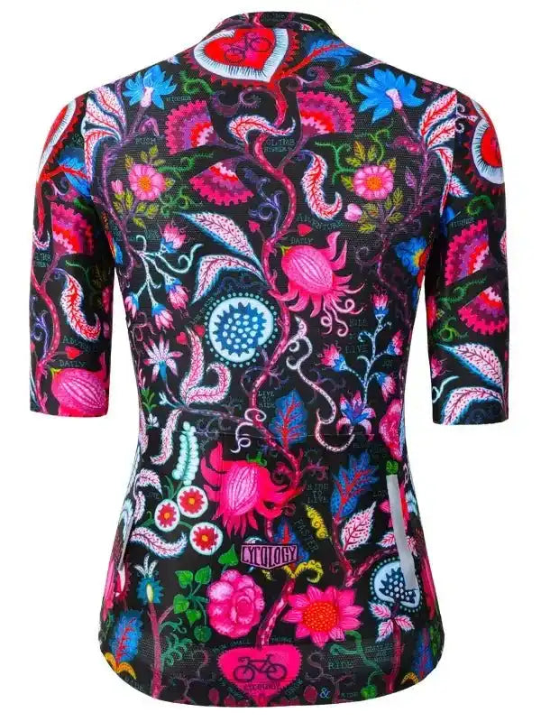 Vibrant floral cycling jersey with pink, blue, and green patterns on black background, featuring 3/4 sleeves and reflective details.