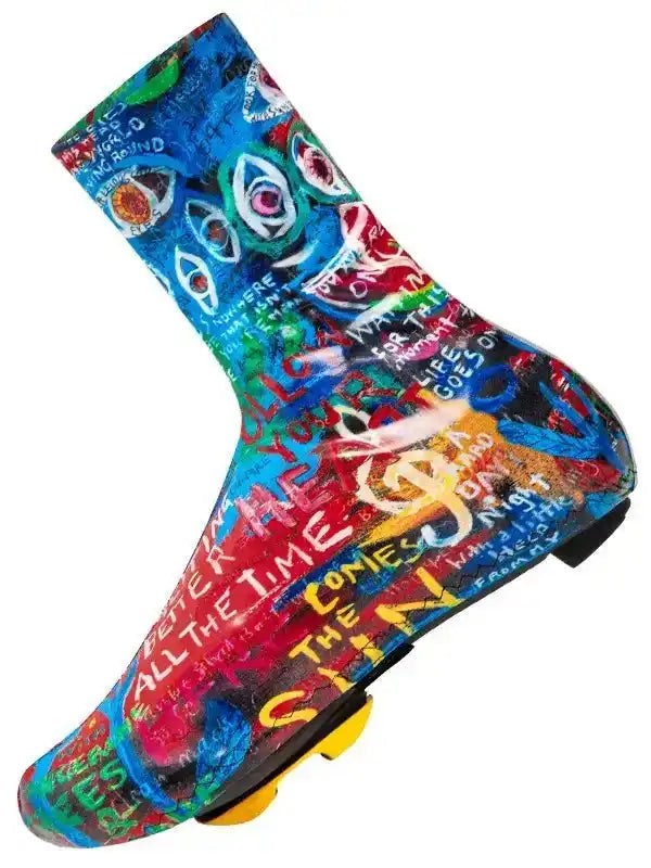 Colorful graffiti-style cycling shoe cover with bold text and eye graphics for road biking