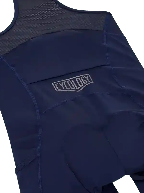 Navy blue cycling bib shorts with mesh back panel and Cycology logo, designed for comfort and performance.