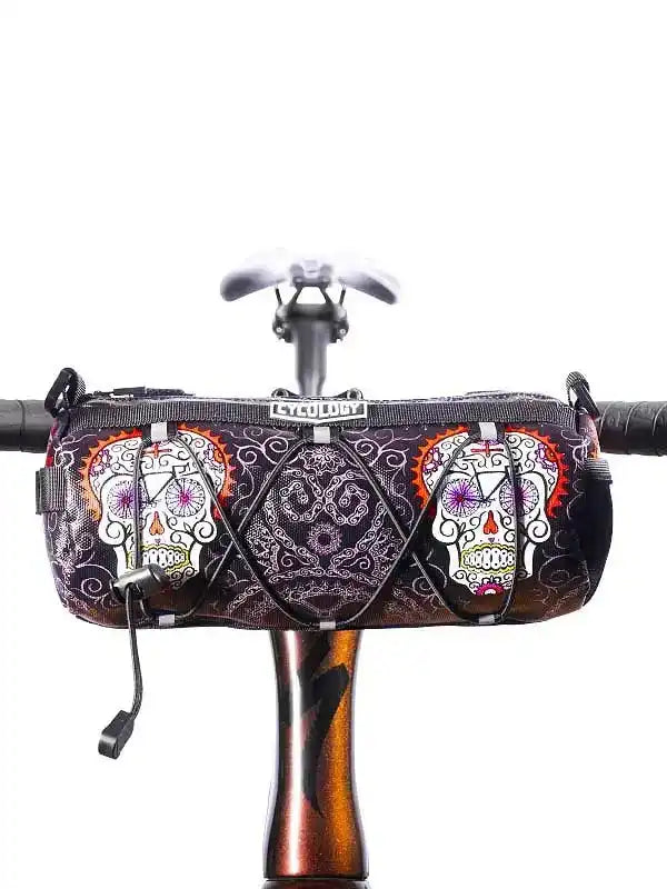 Cycology handlebar bag with sugar skull design, mounted on bike for cycling storage