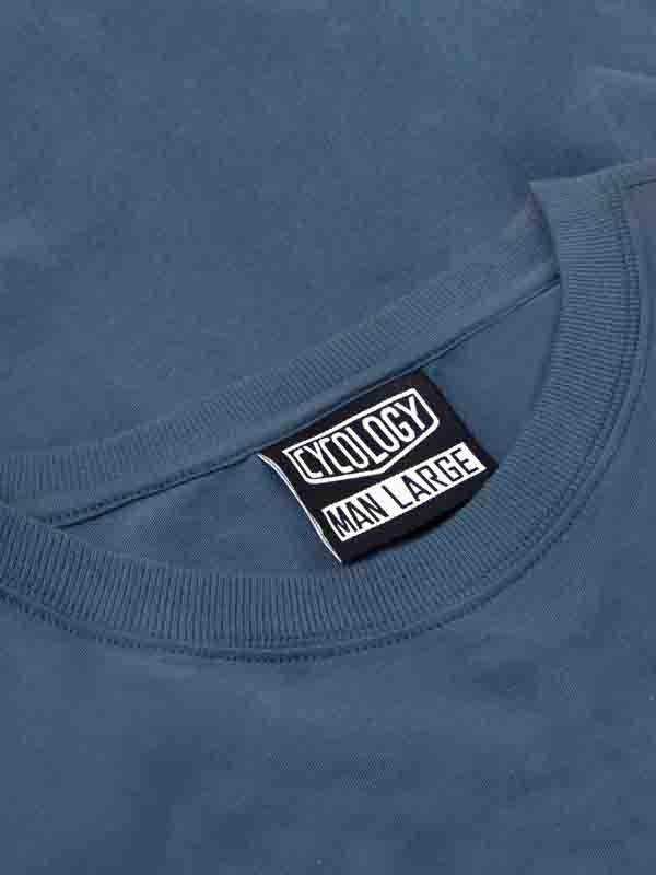 Cycology men's large size tag on blue cycling apparel, showcasing brand label detail