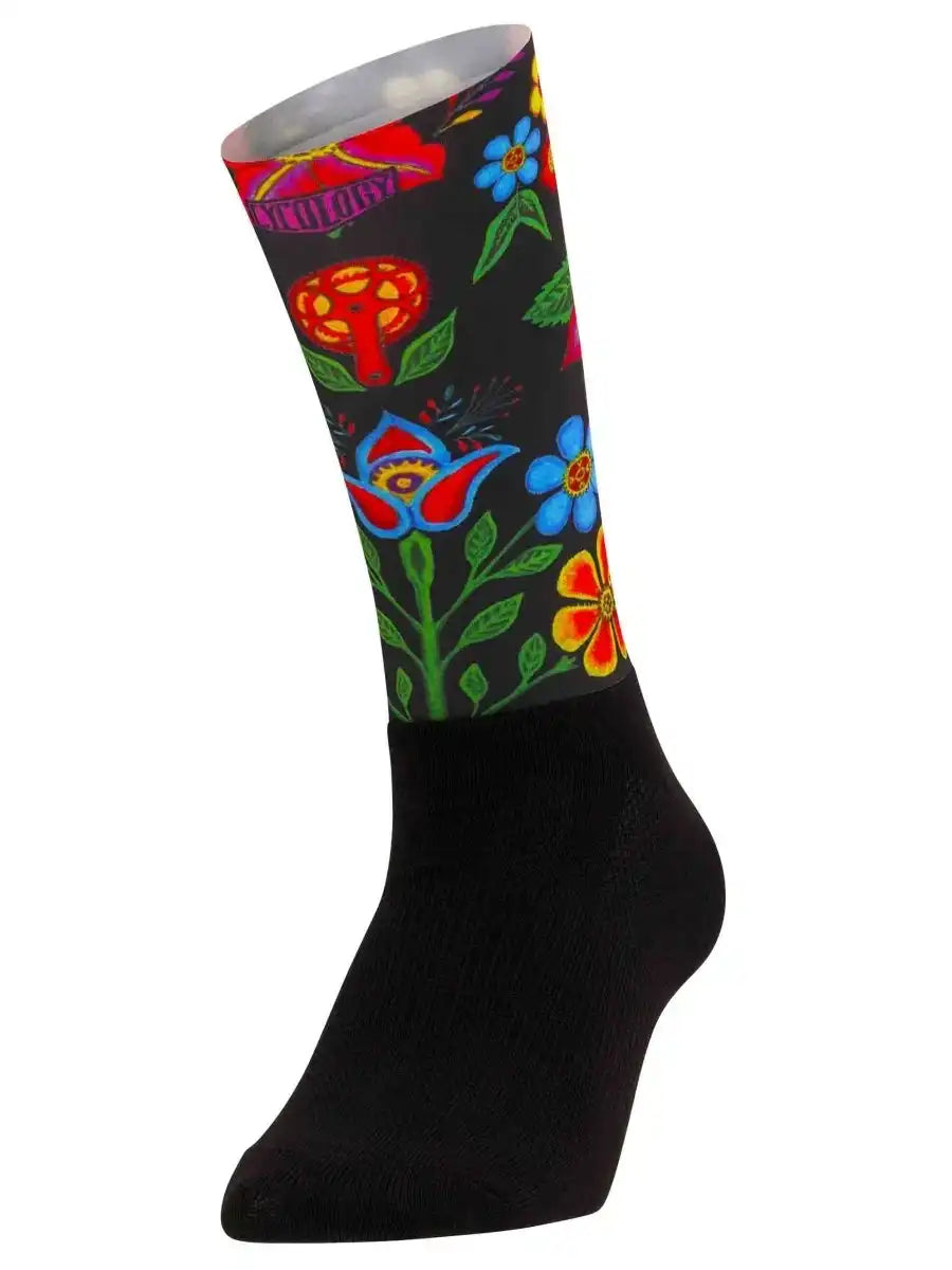 Black cycling sock with colorful floral and mushroom print, ideal for men's and women's bike rides