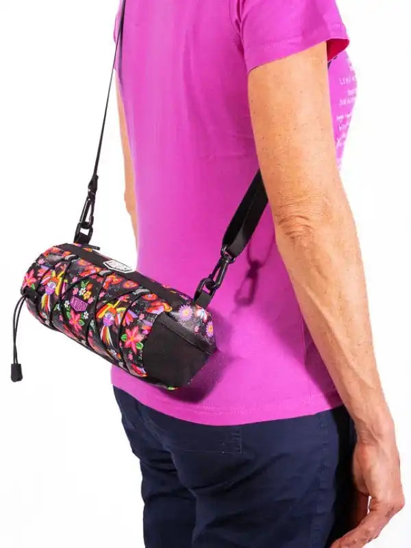Colorful floral cycling waist bag with adjustable strap worn by woman in pink shirt