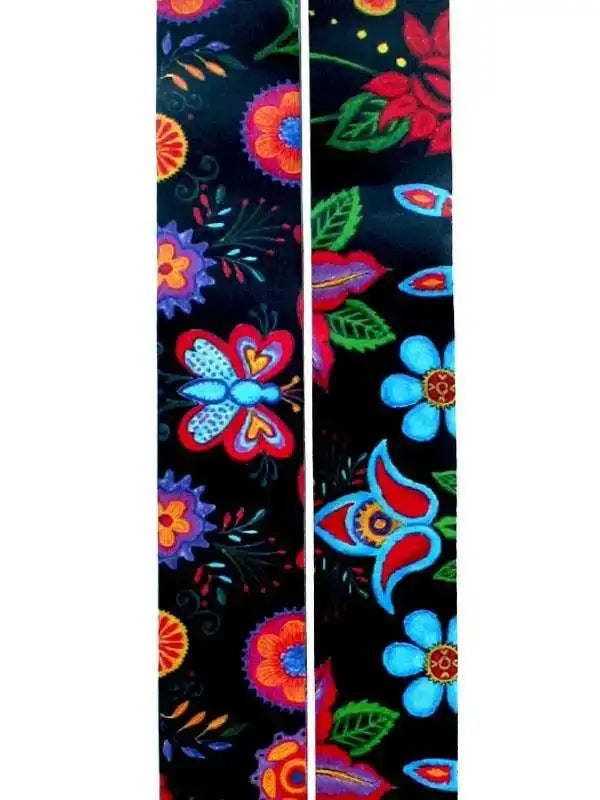 Vibrant floral cycling jersey fabric with bold butterflies and blooms on black background