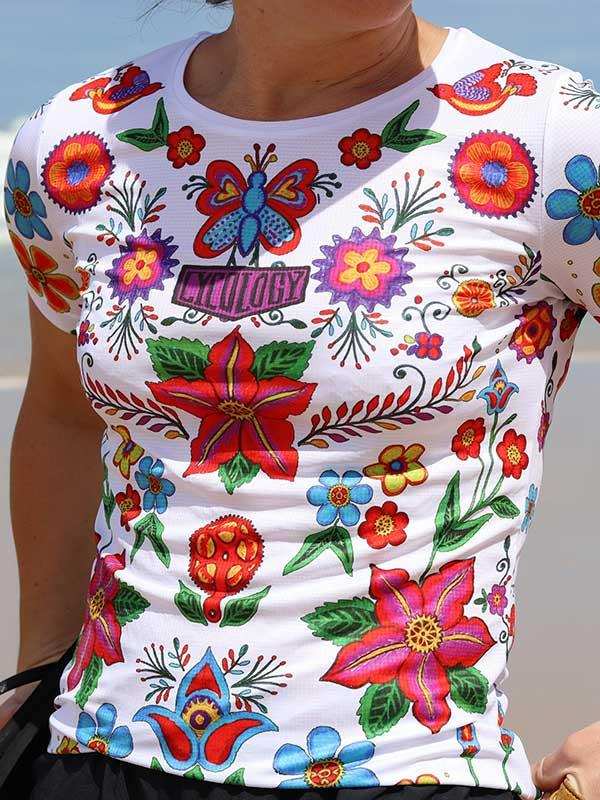 Vibrant floral and butterfly print women's cycling jersey with colorful botanical designs