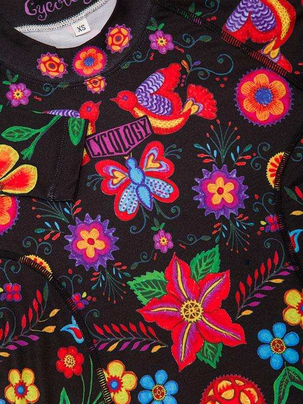 Vibrant floral and bird print cycling jersey with colorful embroidery on black fabric