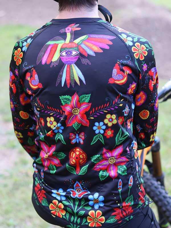 Vibrant floral and bird patterned cycling jersey with bold colors, perfect for mountain biking adventures.