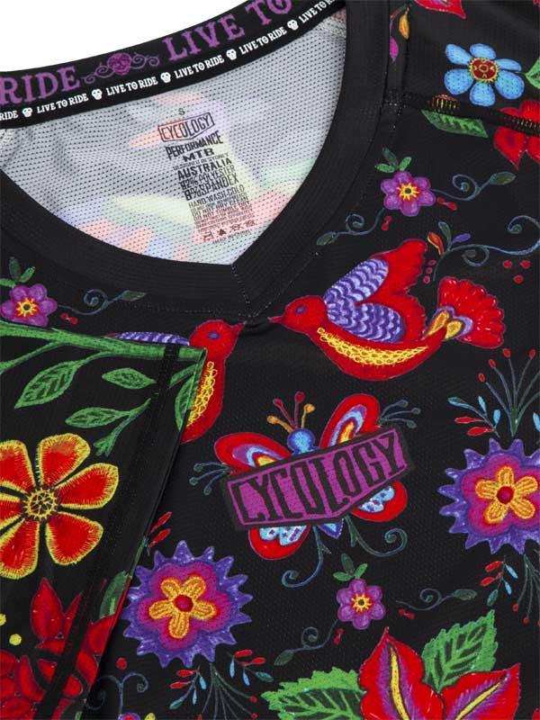 Vibrant floral and bird pattern cycling jersey with bold colors and 'Cycology' logo