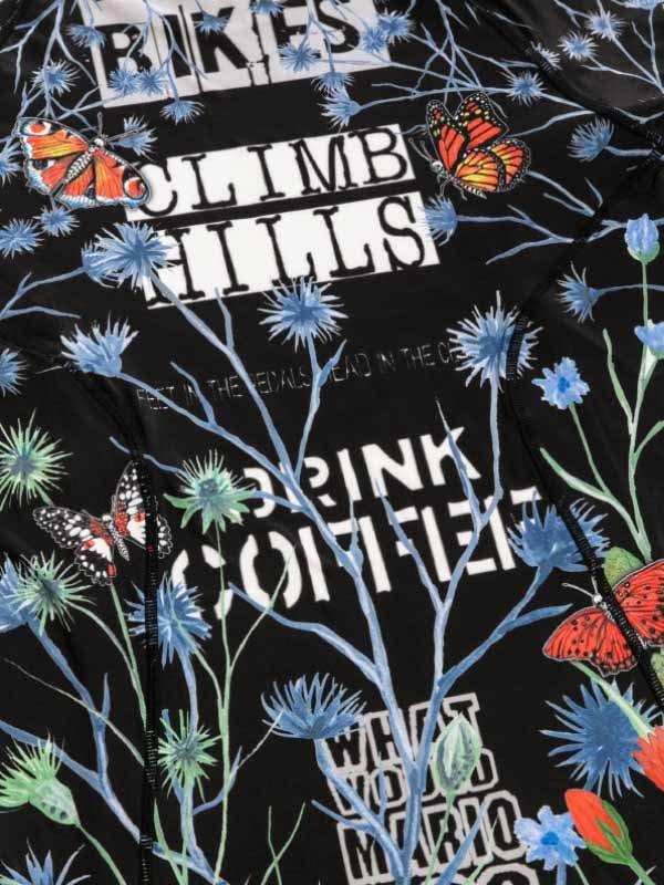Black cycling jersey with 'CLIMB HILLS' text, butterflies, blue flowers, and coffee slogan for road bike riders