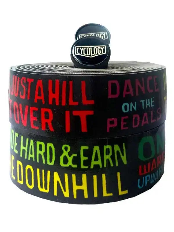 Cycology bike handlebar tape with bold colorful cycling slogans like 'Just a Hill' and 'Dance on the Pedals'