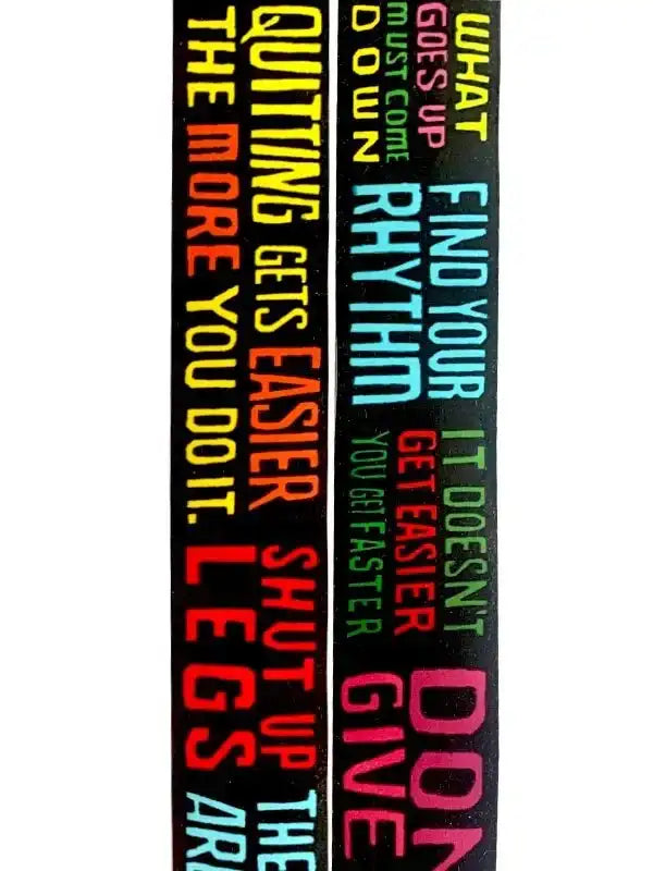Motivational cycling socks with bold colorful text like 'Quitting gets easier' and 'Find your rhythm'
