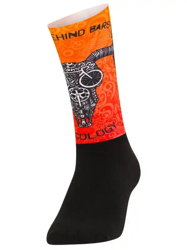 Cycling sock with bold orange design, bull skull graphic, and 'Behind Bars' text for men's and women's bike rides.