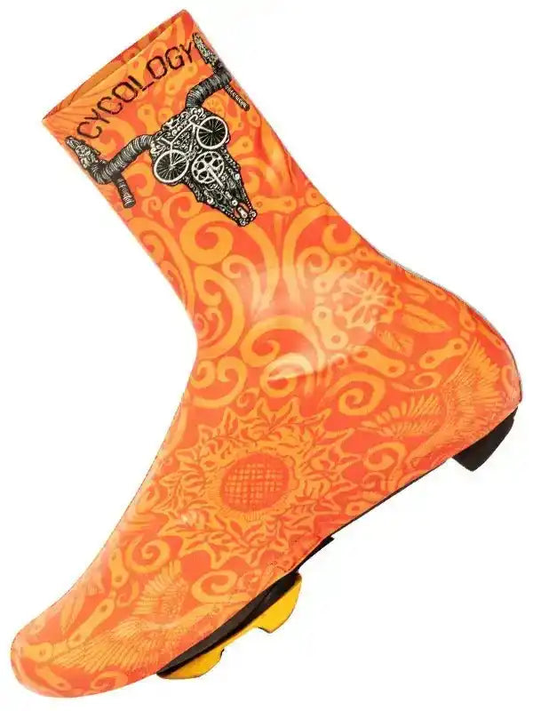 Orange cycling shoe cover with skull and bike gear design, windproof and waterproof for road biking