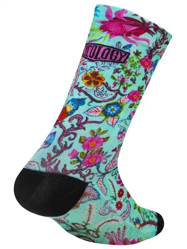Colorful floral cycling sock with black toe and heel, featuring vibrant botanical design for bike rides.