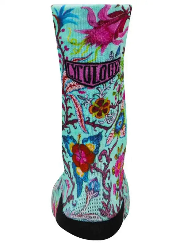 Colorful floral cycling sock with vibrant patterns and black toe, designed for comfort and style on rides.