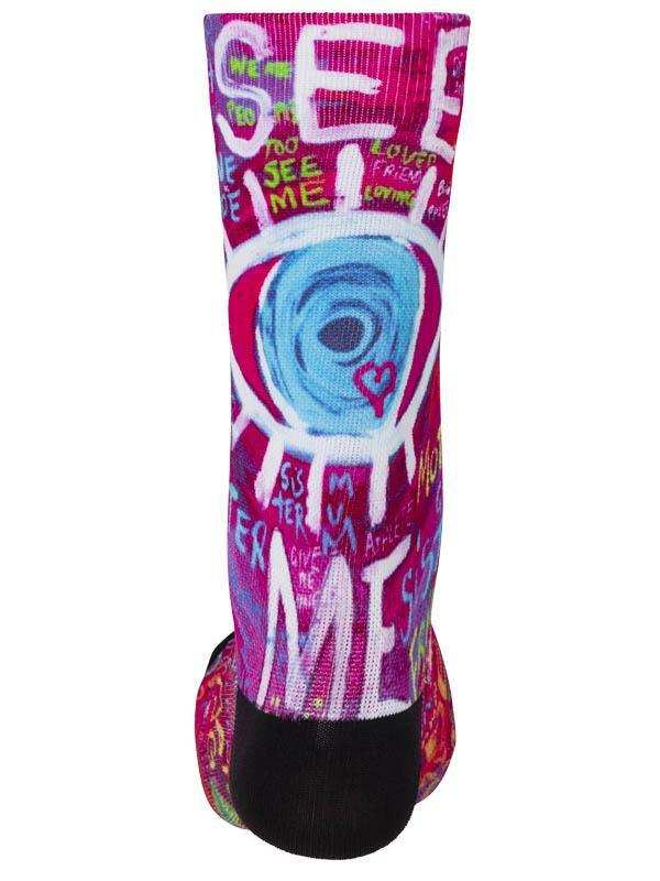 Colorful cycling sock with graffiti-style 'SEE ME' design, vibrant pink and blue art, black toe heel