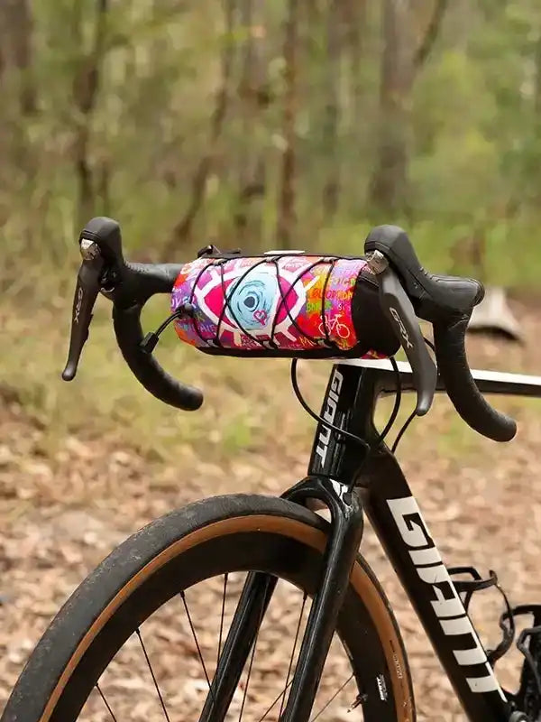 Colorful cycling frame bag on road bike handlebars, ideal for bikepacking and trail rides
