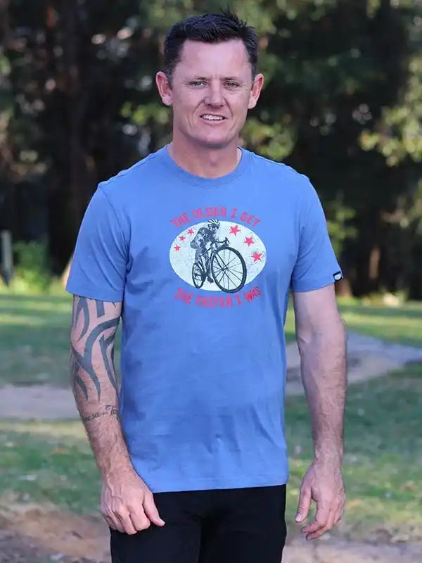 Man wearing blue cycling graphic tee with cyclist design, ideal for bike lovers and outdoor rides