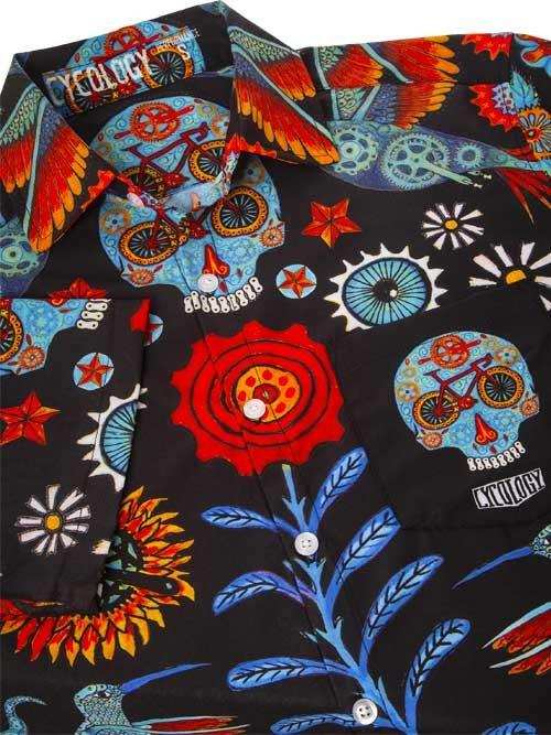 Men's cycling shirt with vibrant sugar skull, bike, and floral print on black fabric