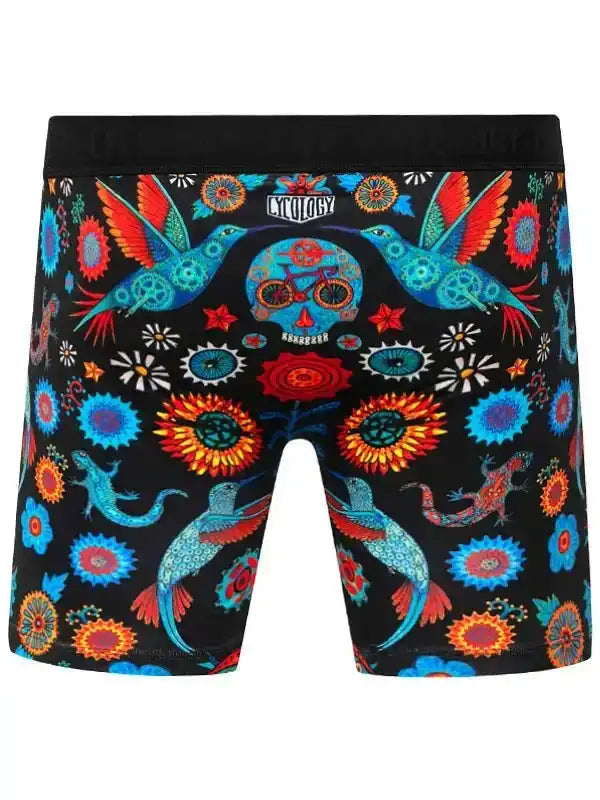 Colorful cycling-themed boxer briefs with hummingbirds, flowers, and bike skull design on black fabric