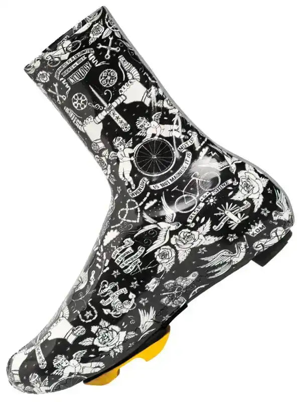 Black cycling shoe cover with white tattoo-style graphics, featuring bikes, roses, and wings for wet weather riding.