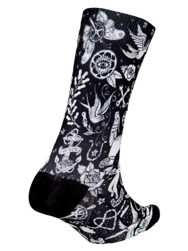 Black cycling sock with white tattoo-style designs including roses, birds, and anchors