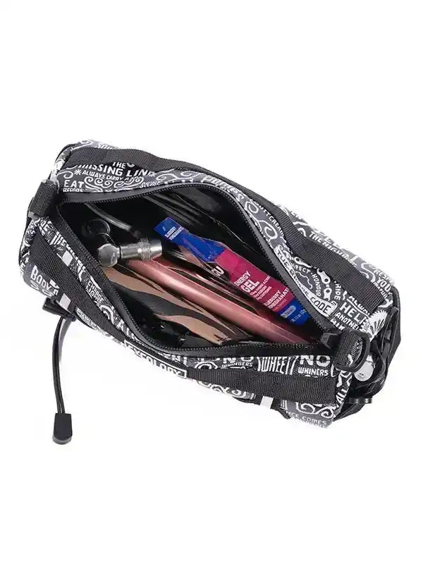 Black cycling accessory bag with white text print, holding tools and nutrition gels for bike rides.