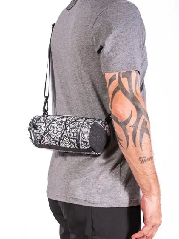 Cycling waist bag with graphic print, worn by man in gray tee, ideal for bike rides and outdoor adventures.
